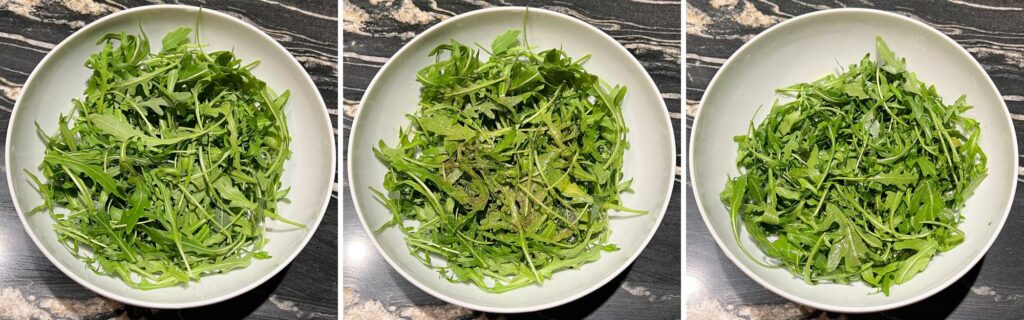 washed arugula in bowl with olive oil, salt and pepper