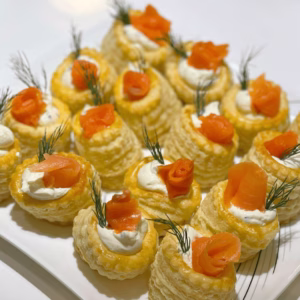 plate with several vol au vent appetizers filled with smoked salmon and cream cheese