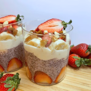 Strawberry banana chia pudding in a glass jar with yogurt and fruit