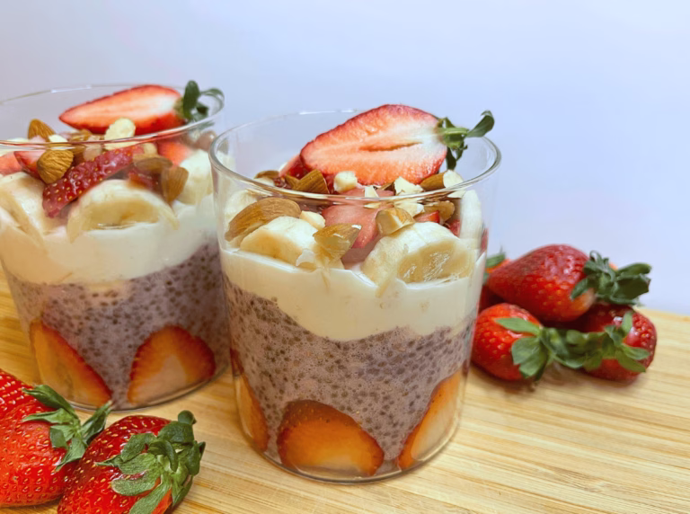 Strawberry banana chia pudding in a glass jar with yogurt and fruit