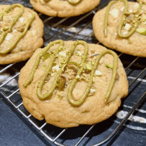 pistachio cookies drizzled with homemade pistachio cream placed on a rack