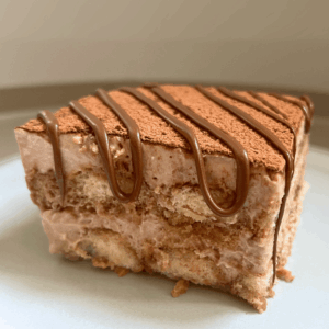 slice of tiramisu nutella in a plate with a drizzle of nutella on top