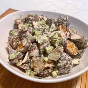 A bowl of roasted potato salad made with red potatoes