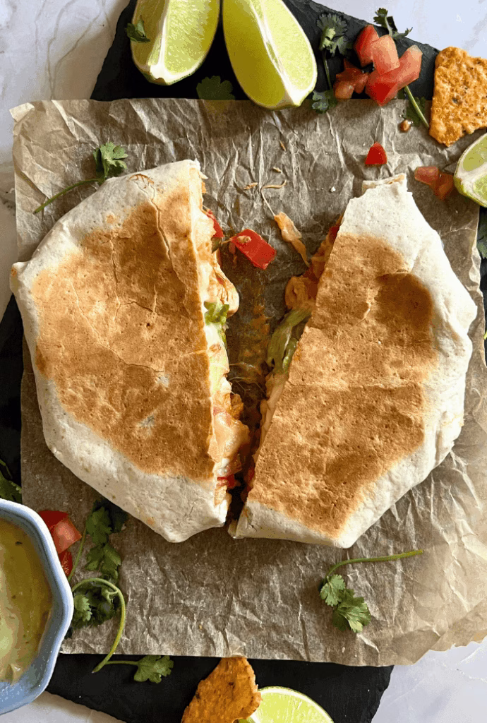 chicken crunchwrap on a plate split in half showing crunch and cheese