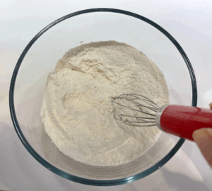 whisking flour baking powder and salt for blinis recipe