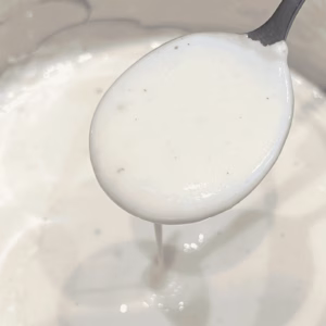 close up of spoonful of bechamel sauce