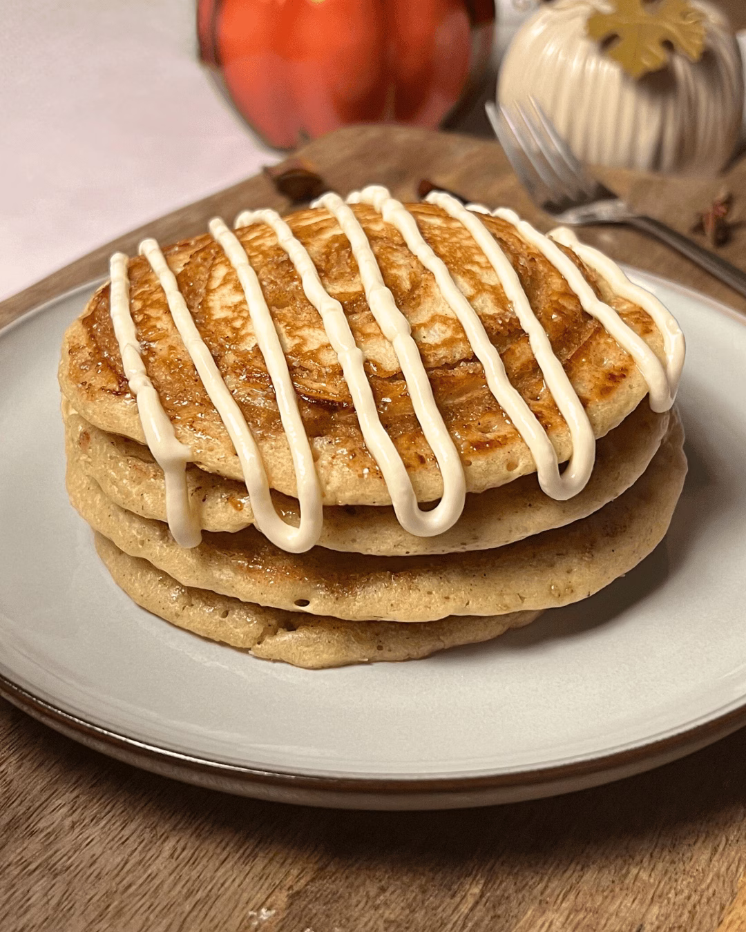 cinnamon roll pancakes stacked in a plate