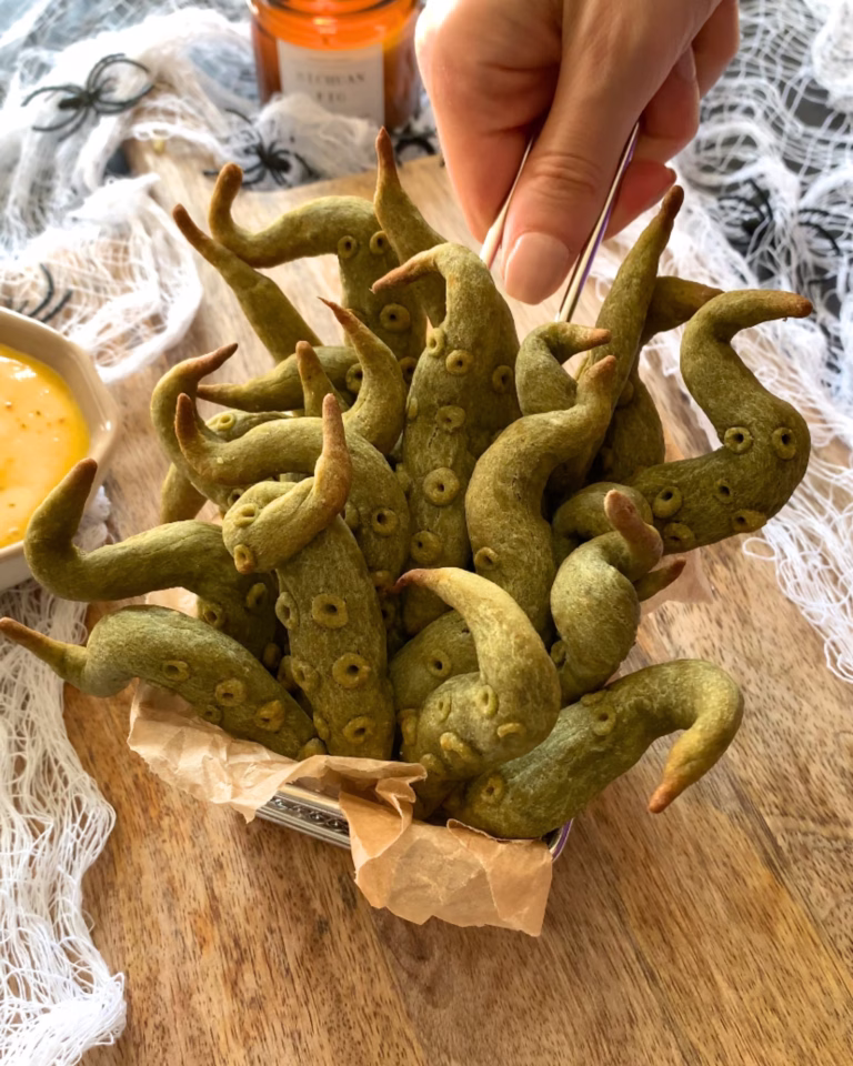 Close-up of baked sweet potato tentacles showing crispy edges and texture, a fun Halloween party food.