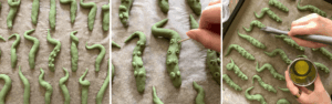 Sweet potato tentacles brushed with olive oil on a baking tray ready for the oven, spooky Halloween snack.