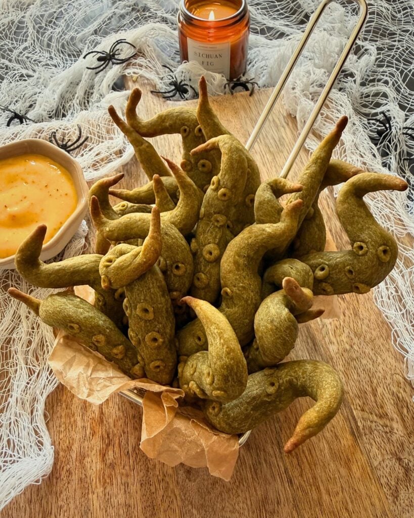 Sweet potato tentacles arranged in a mini French fries basket with honey mustard sauce, perfect Halloween food idea.