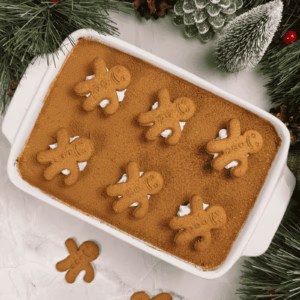 gingerbread tiramisu in a dish topped with cocoa powder for a festive christmas dessert