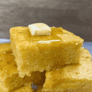 homemade cornbread with butter and honey on top