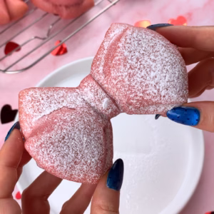 soft pink bow brioches dusted with powdered sugar, perfect for a Valentine's Day brunch