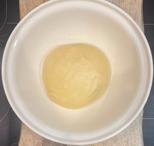 brioche dough placed in a bowl for proofing