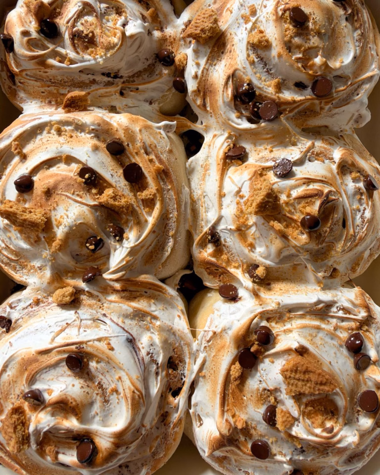s'mores cinnamon rolls topped with a homemade marshmallow fluff
